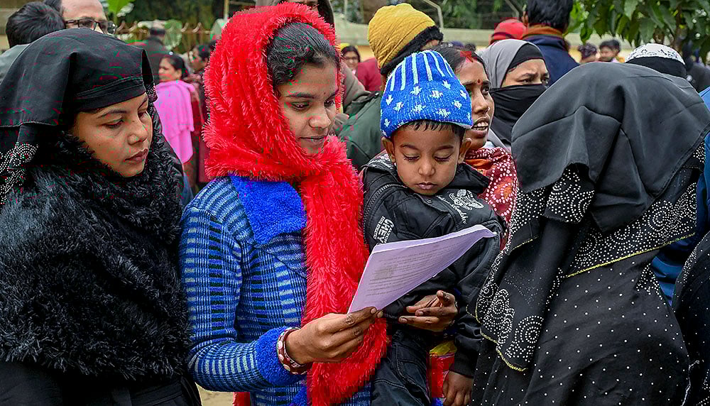 Women wait to enroll for special intensive revision of electoral rolls at Phulia BDO office, in Nadia district, West Bengal. - | Photo: PTI