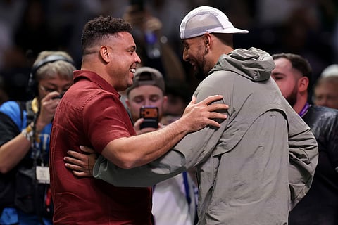 Nick Kyrgios, right, interacts with former footballer Ronaldo after the Battle of the Sexes match between Aryna Sabalenka and Nick Kyrgios, in Dubai, United Arab Emirates.