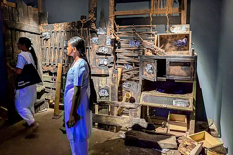 Visitors look at artist Dhiraj Rabha's work at the Kochi-Muziris Biennale, at Fort Kochi, in Kerala. Rabha's exhibition 'The Quiet Weight of Shadows' explores the history of insurgency in Assam under the Armed Forces (Special Powers) Act. 