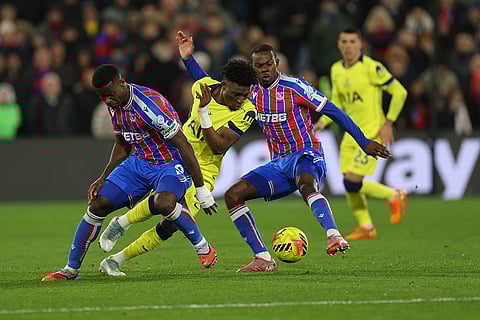 Crystal Palace's Marc Guehi, left, and Tyrick Mitchell, second from right, challenge for the ball with Tottenham's Mohammed Kudus, second from left, during the English Premier League soccer match between Crystal Palace and Tottenham Hotspur in London.