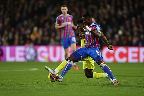 Crystal Palace's Marc Guehi, right, and Tottenham's Mohammed Kudus challenge for the ball during the English Premier League soccer match between Crystal Palace and Tottenham Hotspur in London.