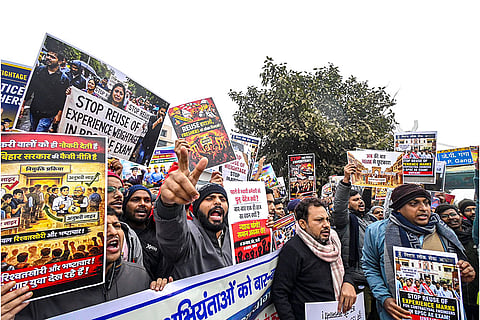 Bihar Public Service Commission aspirants hold placards during a protest against the reuse of previously selected candidates in the BPSC Assistant Engineer recruitment, in Patna.