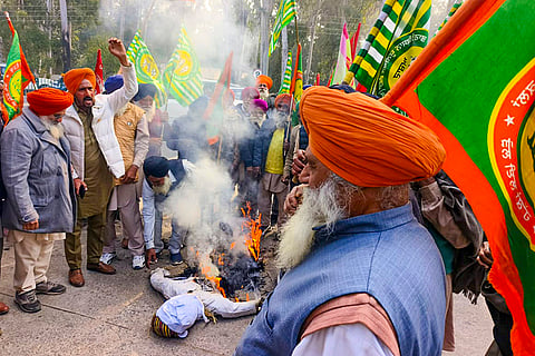 Members of Kisan Mazdoor Union Morcha burn an effigy during a protest against the VB-G RAM G Bill 2025 implemented by the Union government, in Patiala.