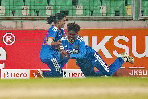 India's Gunalan Kamalini, right, takes the catch of Sri Lanka's Kavisha Dilhari as she nearly collides with Amanjot Kaur during the fourth T20 International cricket match of a series between India Women and Sri Lanka Women, at Greenfield International Stadium, in Thiruvananthapuram, Kerala.