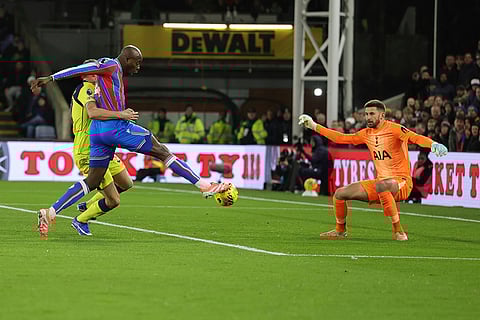 Crystal Palace's Jean-Philippe Mateta, centre, shoots on target as Tottenham's goalkeeper Guglielmo Vicario challenges during the English Premier League soccer match between Crystal Palace and Tottenham Hotspur in London.