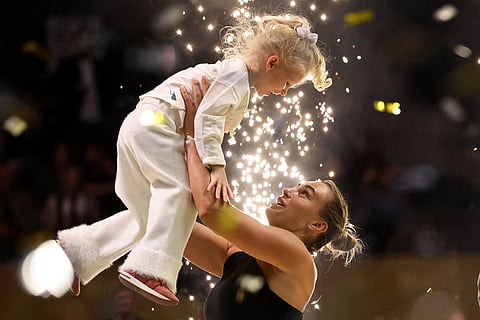 Aryna Sabalenka holds her goddaughter Nicole after losing against Nick Kyrgios in the Battle of the Sexes tennis match, in Dubai, United Arab Emirates.
