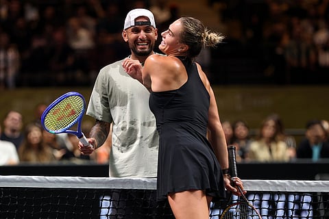 Nick Kyrgios, left, and Aryna Sabalenka interact at the net during their Battle of the Sexes match, in Dubai, United Arab Emirates.