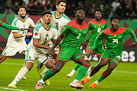 Algeria 1-0 Burkina Faso, AFCON 2025-26: Mahrez Penalty Secures Narrow Win For ALG | Photo: AP/Mosa'ab Elshamy : Algeria and Burkina Faso players anticipate a corner kick during the Africa Cup of Nations group E soccer match between Algeria and Burkina Faso in Rabat, Morocco.