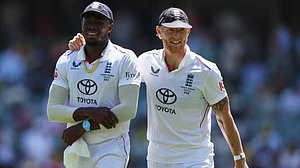 | Photo: AP/James Elsby : England's Ben Stokes, right, walks with teammate Jofra Archer after dismissing Australia during play on day four of the third Ashes cricket test between England and Australia in Adelaide, Australia, Saturday, Dec. 20, 2025.