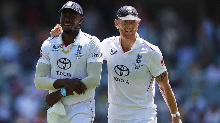 England's Ben Stokes, right, walks with teammate Jofra Archer after dismissing Australia during play on day four of the third Ashes cricket test between England and Australia in Adelaide, Australia, Saturday, Dec. 20, 2025. - | Photo: AP/James Elsby