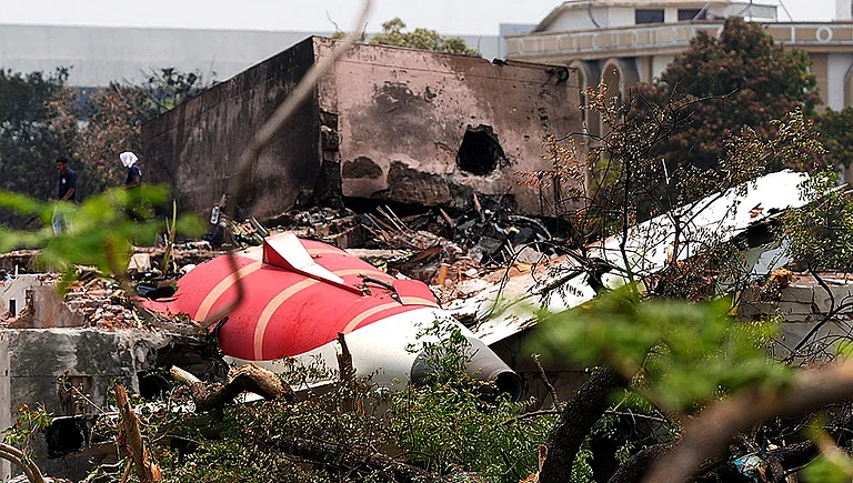 The wing of Air India flight 171 lies broken in the dust, just outside Meghnagar. - Photo: Dinesh Parab/Outlook