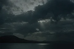 | Stills from the latest film, A Breath Held Long,By Sudarshan Shetty : He walked in the rain with an excuse of a lost umbrella that he once borrowed from his mother as the raindrops poured down his cheeks like exaggerated salty sorrow that slowly pooled in his pockets submerging the cashless leather wallet that made him happy to imagine he was losing a lifetime of fortune to a grand deluge