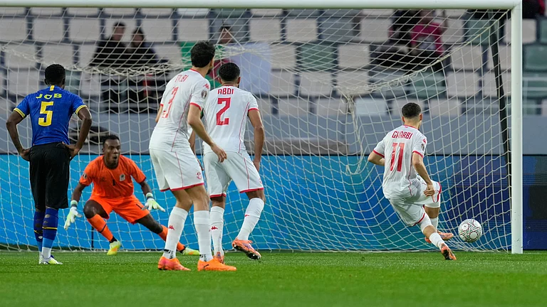 Tunisia's Ismael Gharbi, right, scores from a penalty kick during the Africa Cup of Nations group C soccer match between Tanzania and Tunisia in Rabat, Morocco, Tuesday, Dec. 30, 2025. - (AP Photo/Mosa'ab Elshamy)