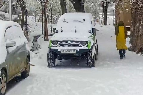A vehicle covered in a thick layer of snow after fresh snowfall, in Drass, Ladakh.