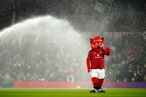 The Manchester United mascot Fred the Red walks on the pitch ahead of the English Premier League soccer match between Manchester United and Wolverhampton Wanderers in Manchester, England.