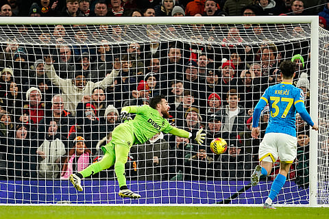 Wolverhampton Wanderers' goalkeeper Jose Sa prevents a goal during the English Premier League soccer match between Manchester United and Wolverhampton Wanderers in Manchester, England.
