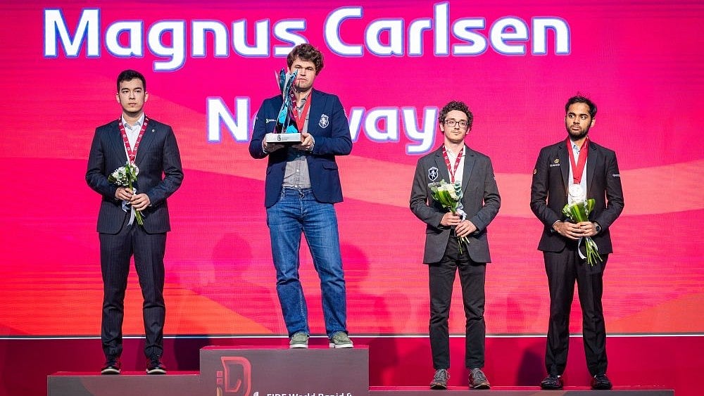 Norway's Magnus Carlsen with the FIDE World Blitz Championship 2025 title, with India's Arjun Erigaisi with the bronze medal behind. - | Photo: X/FIDE_chess