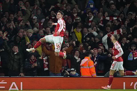 Arsenal's Martin Zubimendi, top, celebrates after scoring his side's second goal during the English Premier League soccer match between Arsenal and Aston Villa in London.