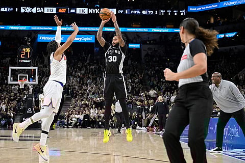 San Antonio Spurs forward Julian Champagnie (30) shoots against New York Knicks guard Jalen Brunson during the second half of an NBA basketball game in San Antonio.