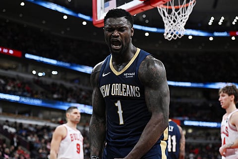 New Orleans Pelicans' Zion Williamson (1) celebrates after making a basket and getting fouled during the first half of an NBA basketball game against the Chicago Bulls in Chicago.