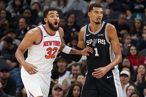 San Antonio Spurs center Victor Wembanyama (1) guards New York Knicks center Karl-Anthony Towns during the second half of an NBA basketball game in San Antonio.