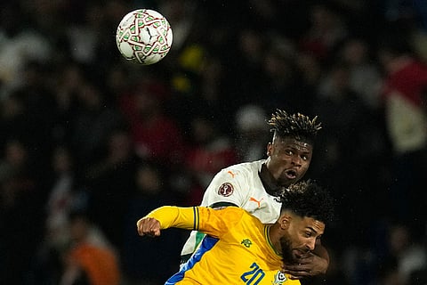 Uganda's Isaac Muleme and Ivory Coast's Emmanuel Agbadou compete for a header during the Africa Cup of Nations group F soccer match between Gabon and Ivory Coast, in Marrakech, Morocco.