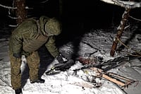 AP : This image made from undated video provided by the Russian Defense Ministry Press Service on Wednesday, Dec. 31, 2025, shows a man in camouflage standing by a downed drone at an undisclosed location that it said was one of the Ukrainian drones involved in an alleged attack on a residence.