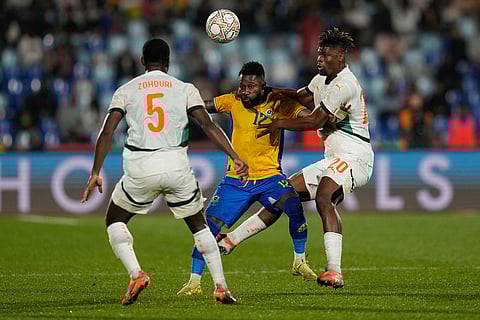 Gabon's Guelor Kanga is challenged by Ivory Coast's Emmanuel Agbadou during the Africa Cup of Nations group F soccer match between Gabon and Ivory Coast, in Marrakech, Morocco.