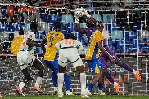 Gabon's goalkeeper Demba Anse Ngoubi makes a save during the Africa Cup of Nations group F soccer match between Gabon and Ivory Coast, in Marrakech, Morocco.