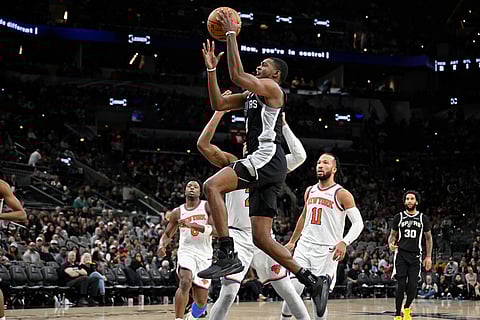 San Antonio Spurs guard De'Aaron Fox (4) goes to the basket during the second half of an NBA basketball game against the New York Knicks in San Antonio.