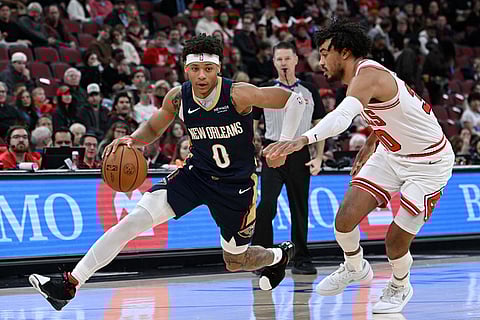 New Orleans Pelicans' Jeremiah Fears (0) drives against Chicago Bulls' Tre Jones during the first half of an NBA basketball game in Chicago.