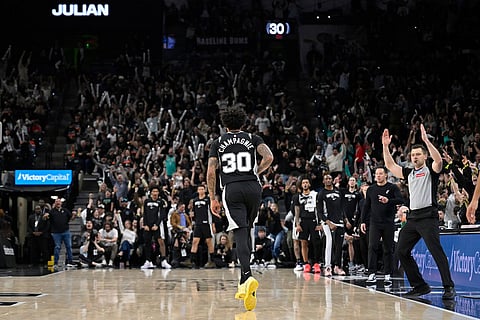 San Antonio Spurs forward Julian Champagnie celebrates a 3-point basket during the second half of an NBA basketball game against the New York Knicks in San Antonio.