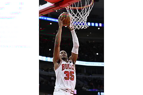 Chicago Bulls' Isaac Okoro goes up for a dunk during the second half of an NBA basketball game against the New Orleans Pelicans in Chicago.