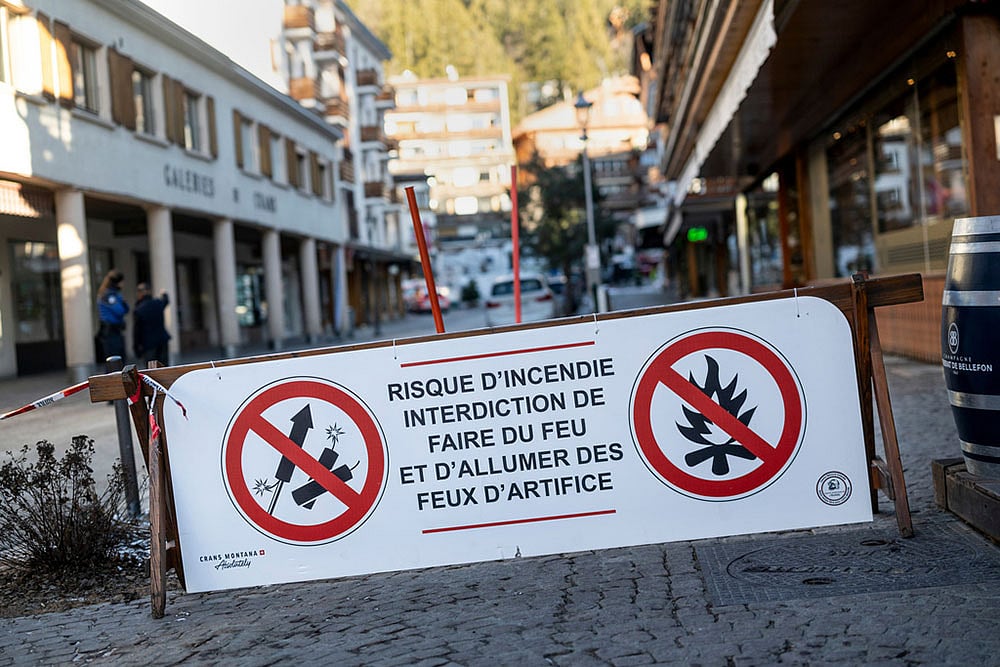 A banner stating that fireworks are prohibited due to the risk of fire is pictured near the area where a fire broke out  at the Le Constellation bar and lounge leaving people dead and injured, during New Year’s celebration, in Crans-Montana, Swiss Alps, Switzerland. - Photo: Alessandro della Valle/Keystone via AP
