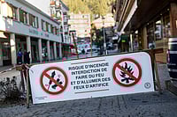 Crans-Montana Bar Fire: Dozens Dead, 115 Injured In Swiss Ski Resort Photo: Alessandro della Valle/Keystone via AP : A banner stating that fireworks are prohibited due to the risk of fire is pictured near the area where a fire broke out at the Le Constellation bar and lounge leaving people dead and injured, during New Year’s celebration, in Crans-Montana, Swiss Alps, Switzerland.