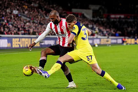 Brentford's Igor Thiago, left, and Tottenham Hotspur's Micky van de Ven battle for the ball during the English Premier League soccer match between Brentford and Tottenham Hotspur in London.