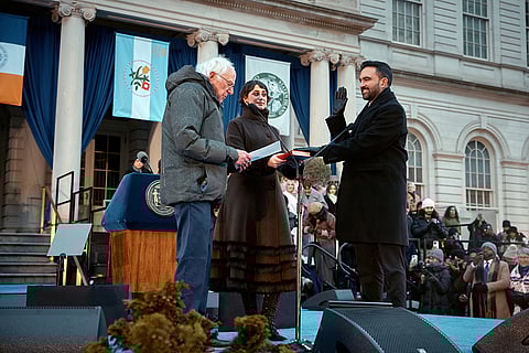 U.S. Sen. Bernie Sanders, I-Vt., left, administers the oath of office to Mayor Zohran Mamdani, right, as Rama Duwaji, center, holds the Quran during Mamdani's inauguration ceremony in New York. 