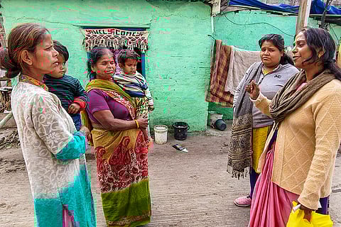 Residents discuss with municipal workers at Bhagirathpura amid the contaminated tap water crisis where several people died and fell ill, in Indore.