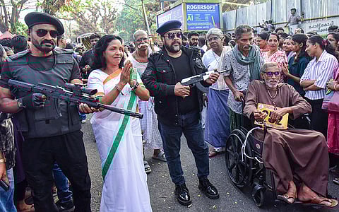 People take part in the annual Cochin Carnival rally, in Kochi, Kerala.