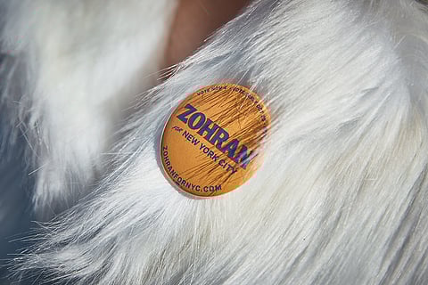 A Mamdani supporter wears a pin outside the City Hall before Zohran Mamdani's inauguration in New York. 