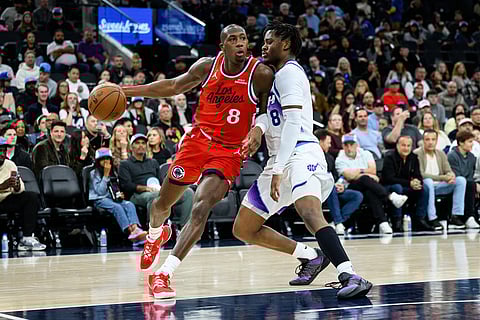 Los Angeles Clippers guard Kris Dunn (8) drives the ball against Utah Jazz guard Isaiah Collier (8) during the first half of an NBA basketball game in Inglewood, California.