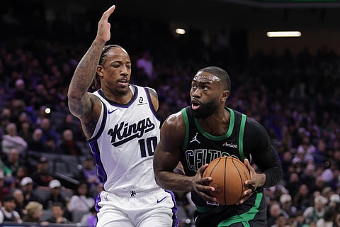 Boston Celtics guard Jaylen Brown, right, drives towards the basket around Sacramento Kings guard Demar Derozan (10) during the first half of an NBA basketball game in Sacramento, California.