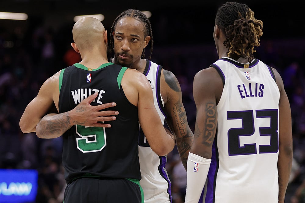 Boston Celtics guard Derrick White (9) and Sacramento Kings guard Demar Derozan, behind, hug before times runs out during the second half of an NBA basketball game in Sacramento, California.  - | Photo: AP/Scott Marshall