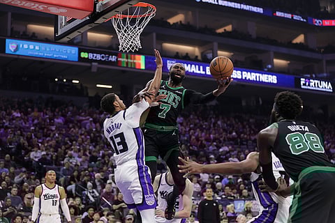 Boston Celtics guard Jaylen Brown (7) attempts a layup over Sacramento Kings forward Keegan Murray (13) during the first half of an NBA basketball game in Sacramento, California.
