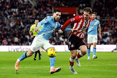 Manchester City's Rayan Cherki and Sunderland's Dennis Cirkin, left, in action during the English Premier League soccer match between Sunderland and Manchester City in Sunderland, England.