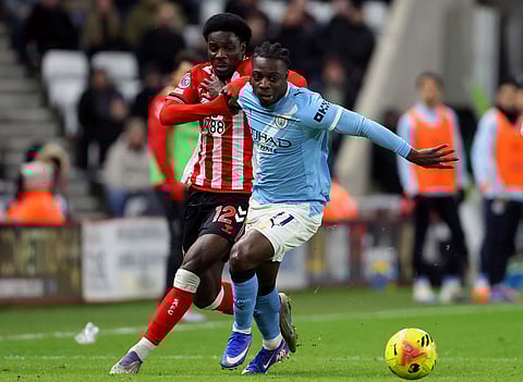 Sunderland's Eliezer Mayenda, left, and Manchester City's Jeremy Doku in action during the English Premier League soccer match between Sunderland and Manchester City in Sunderland, England.
