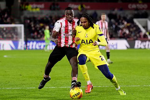 Brentford's Michael Kayode, left, and Tottenham Hotspur's Djed Spence in action during the English Premier League soccer match between Brentford and Tottenham Hotspur in London.