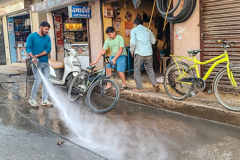 An Indore Municipal Corporation worker during a cleanliness drive after several people were affected due to consumption of contaminated water at Bhagirathpura area, in Indore, Madhya Pradesh. - | Photo: PTI
