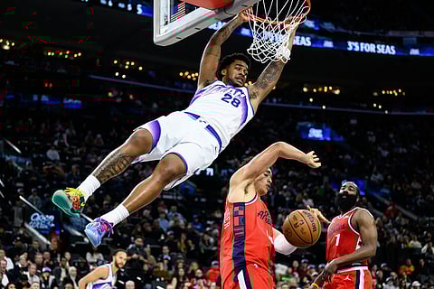 Utah Jazz forward Brice Sensabaugh (28) dunks over Los Angeles Clippers center Yanic Konan Niederhauser, center, during the second half of an NBA basketball game in Inglewood, California.