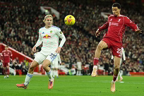 Leeds' Sebastiaan Bornauw, left, tries to block a shot from Liverpool's Hugo Ekitike during the English Premier League soccer match between Liverpool and Leeds United in Liverpool, England.